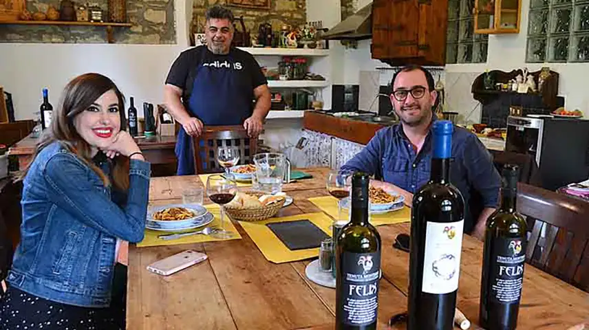 Man and woman enjoying a Tuscan lunch with wine tasting in Chianti