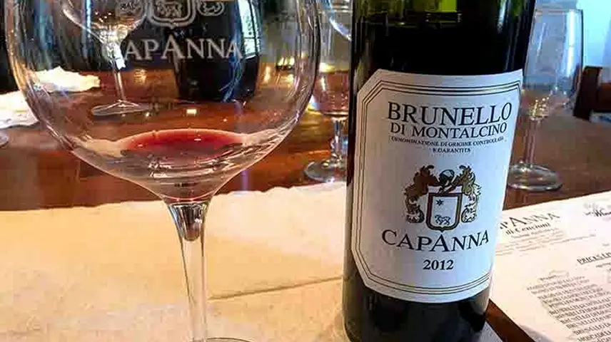 Bottle of Capanna Brunello di Montalcino with a wine glass for wine tasting