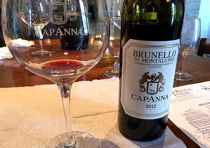 Bottle of Capanna Brunello di Montalcino with a wine glass for wine tasting